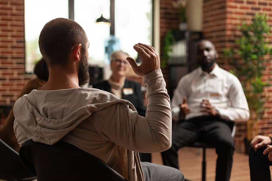 man with addiction sharing mental health issues with group aa meeting talking therapist people having conversation about depression rehabilitation therapy session 1